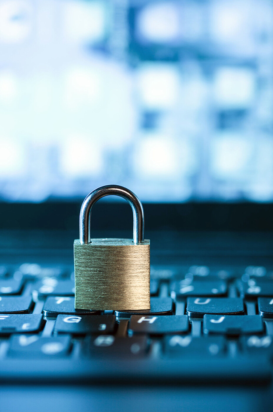cybersecurity concept image of a lock sitting on a keyboard.
