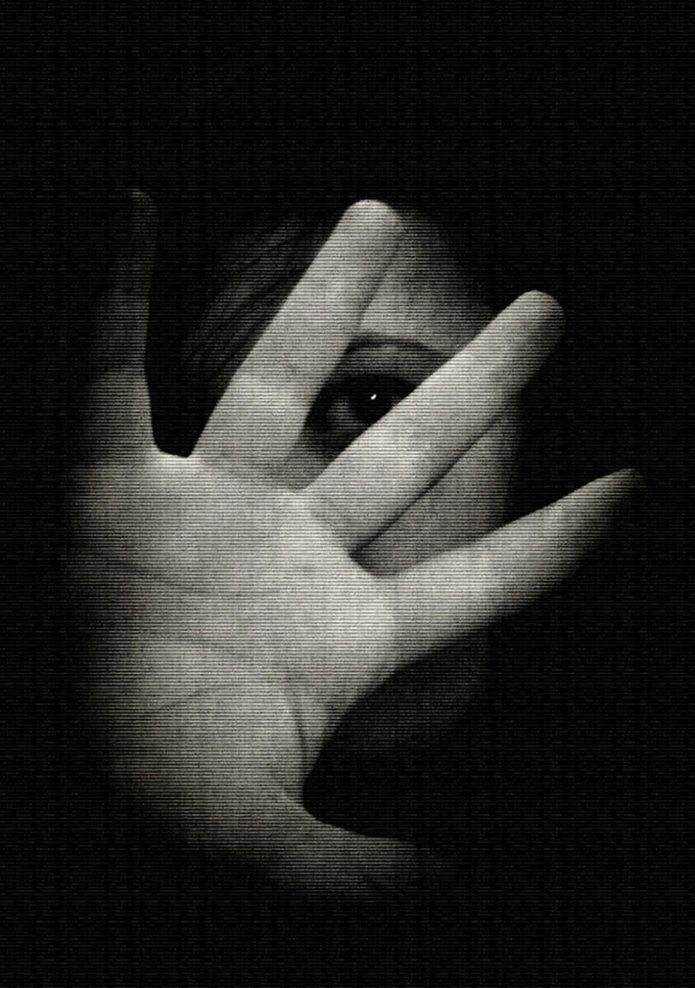 a woman hides behind her hand in a black and white photo