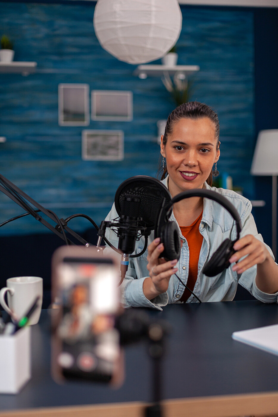 a businesswoman records video on her iPhone.