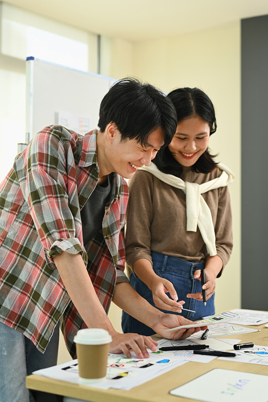 a pair of designers map out web design.