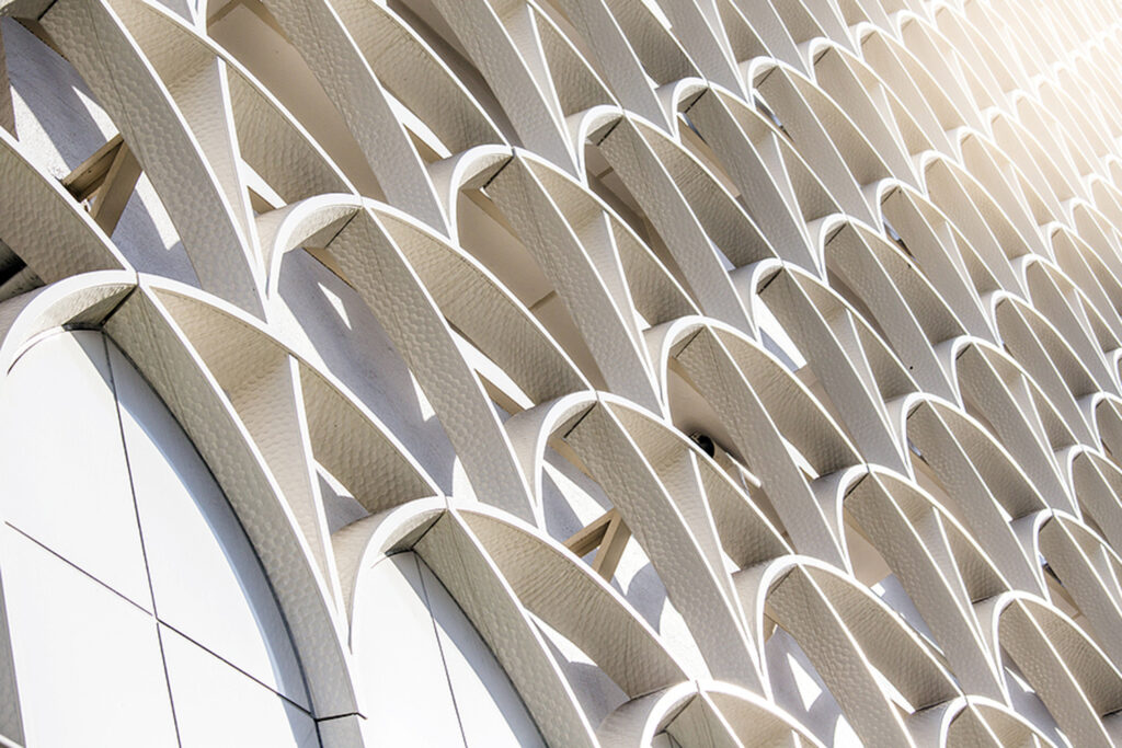 modern architecture with cream arches against a wall.