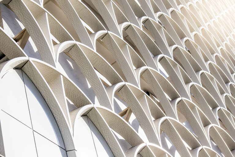 modern architecture with cream arches against a wall.