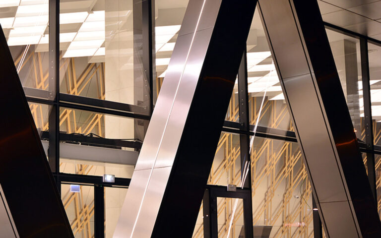 diagonal steel beams in front of glass window panes.