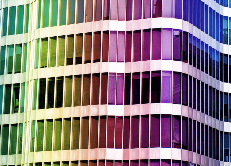 A spectrum of colors across a commercial building's windows.