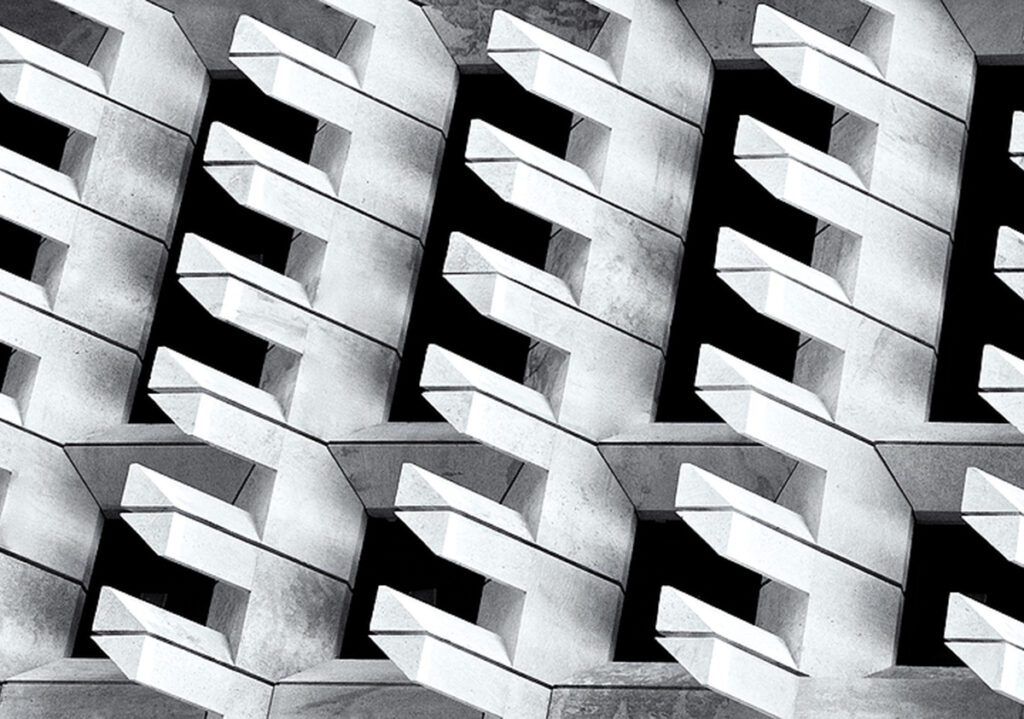 Concrete building with prongs in black and white.